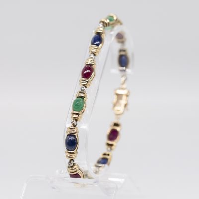 Los Nr. 017 Gliederarmband mit 4 Saphir-, 4 Rubin-, 3 Smaragd-Cabochons und kleinen Achtkant-Diamanten, 1980er Jahre