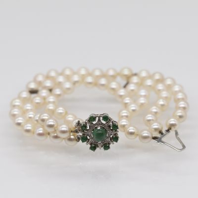Los Nr. 019 3-reihiges Perlenarmband mit weißgoldenem Schloss, 1 Smaragd-Cabochon, 8 kleinen Smaragden und 8 kleinen Achtkant-Diamanten, 70er Jahre